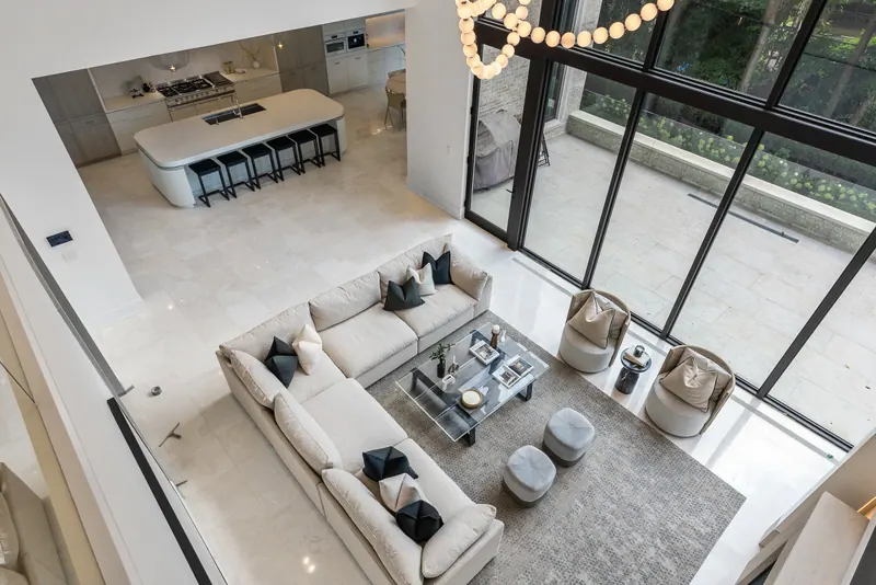Overhead view of a double-height living room with sofa and chandelier