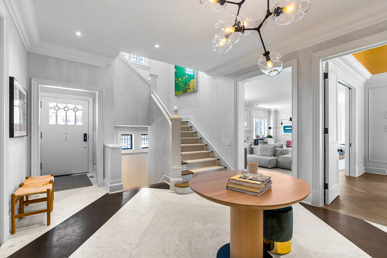 Foyer with sculptural chandelier and staircase