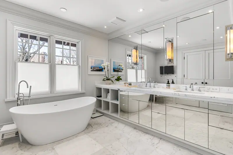 Primary ensuite with freestanding tub and mirrored vanity