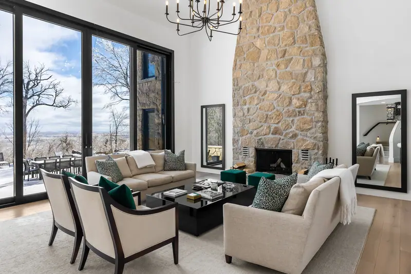 Great room with stone chimney and escarpment views