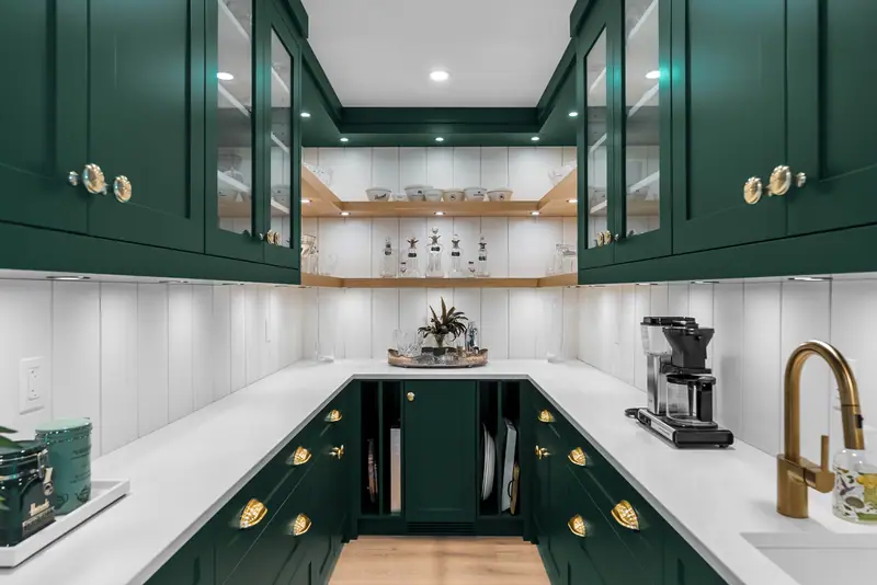 Green butler's pantry with brass hardware