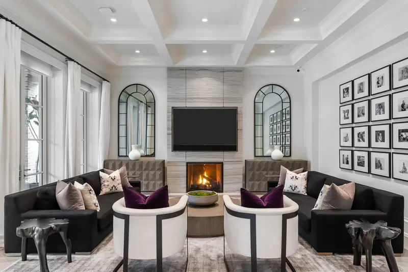 Family room with paired arched windows, fireplace and gallery wall