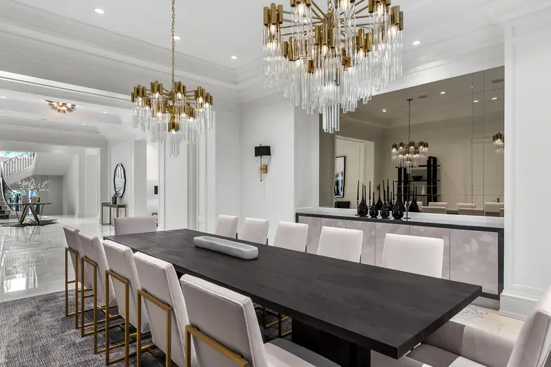 Formal dining room under two crystal chandeliers