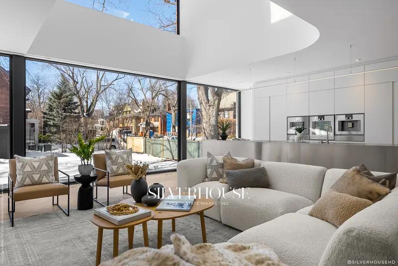 Living room with floor-to-ceiling glass and sculpted ceiling