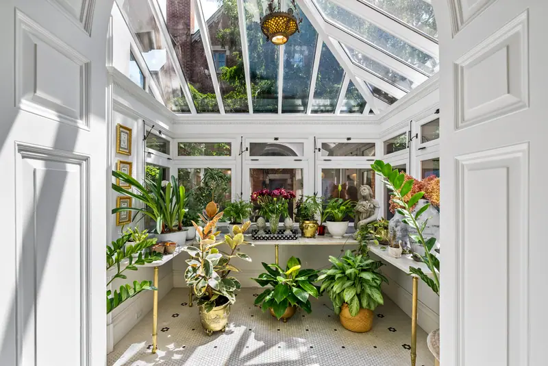 Glass-roofed conservatory filled with plants