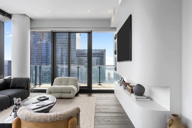 Living room with boucle chairs and skyline views