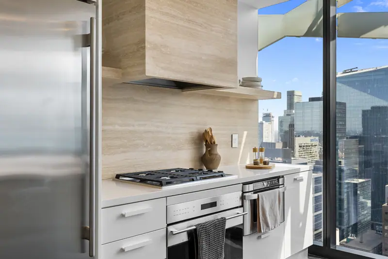 Kitchen with travertine hood and city views