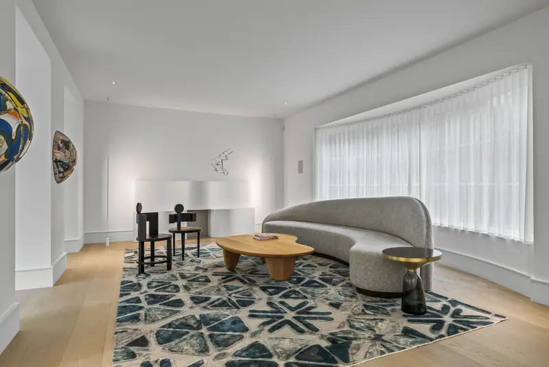 Living room with sculptural sofa and wide garden windows