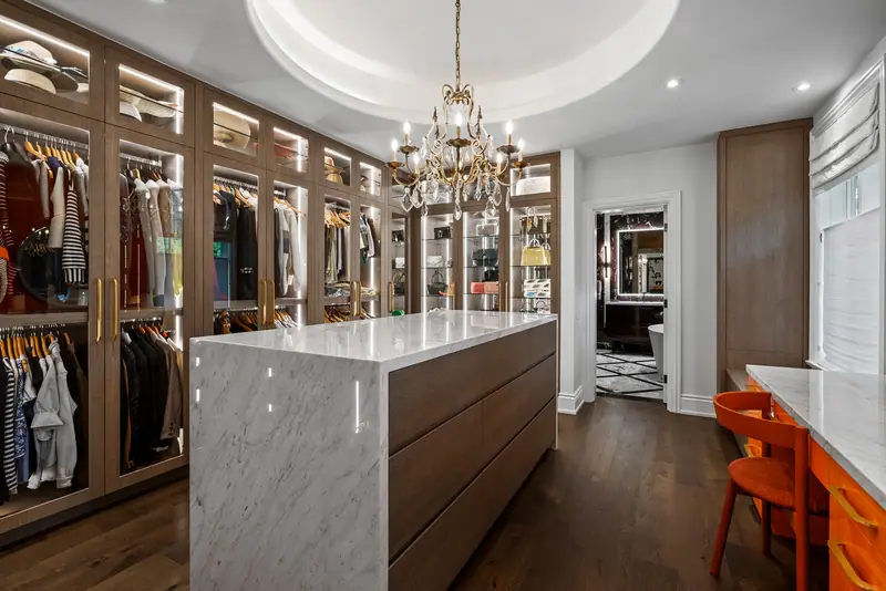 Dressing room with marble island and chandelier