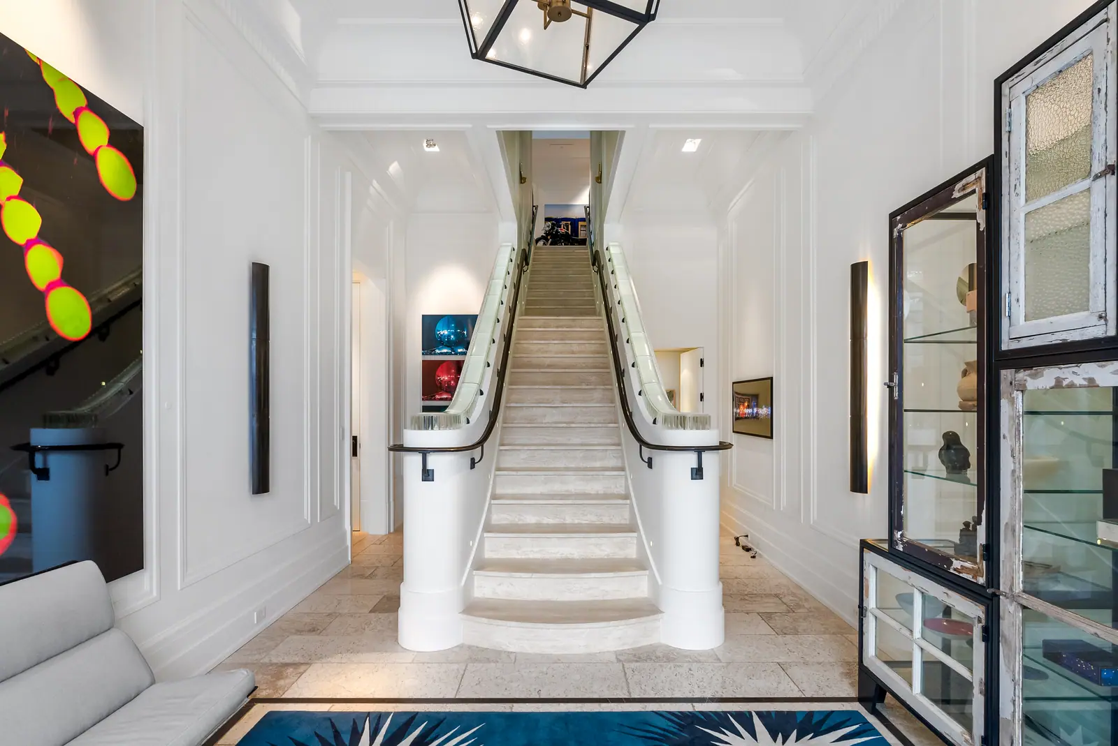 Entrance hall and stone staircase with display cabinets
