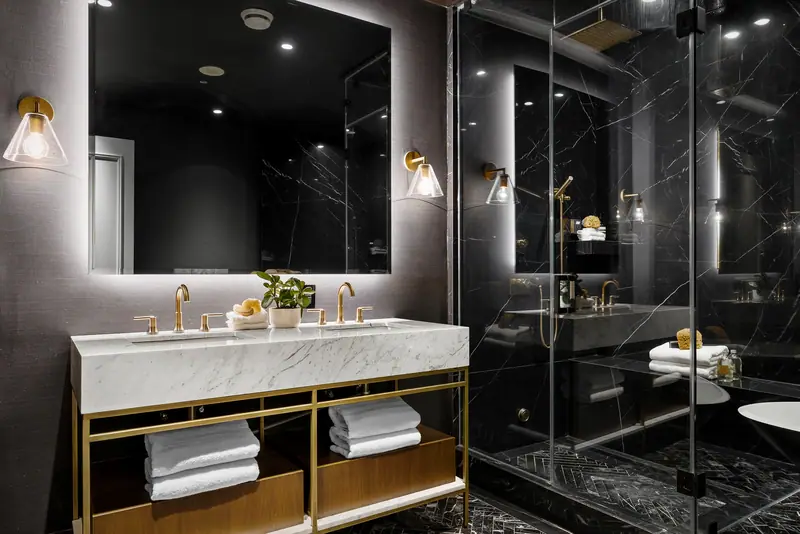 Black marble bathroom with gold fittings