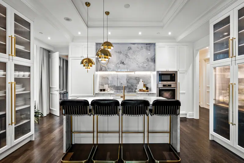 White kitchen with brass pendants