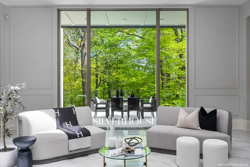 Living room with window wall to the ravine