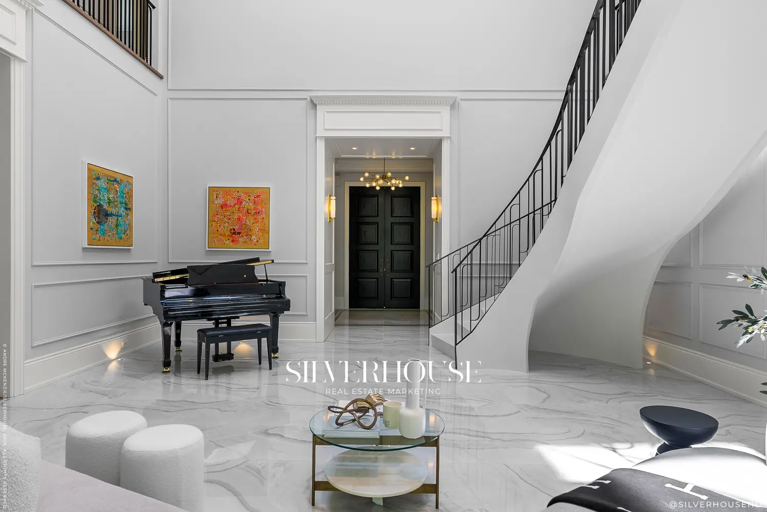Foyer with sculptural curved staircase and grand piano