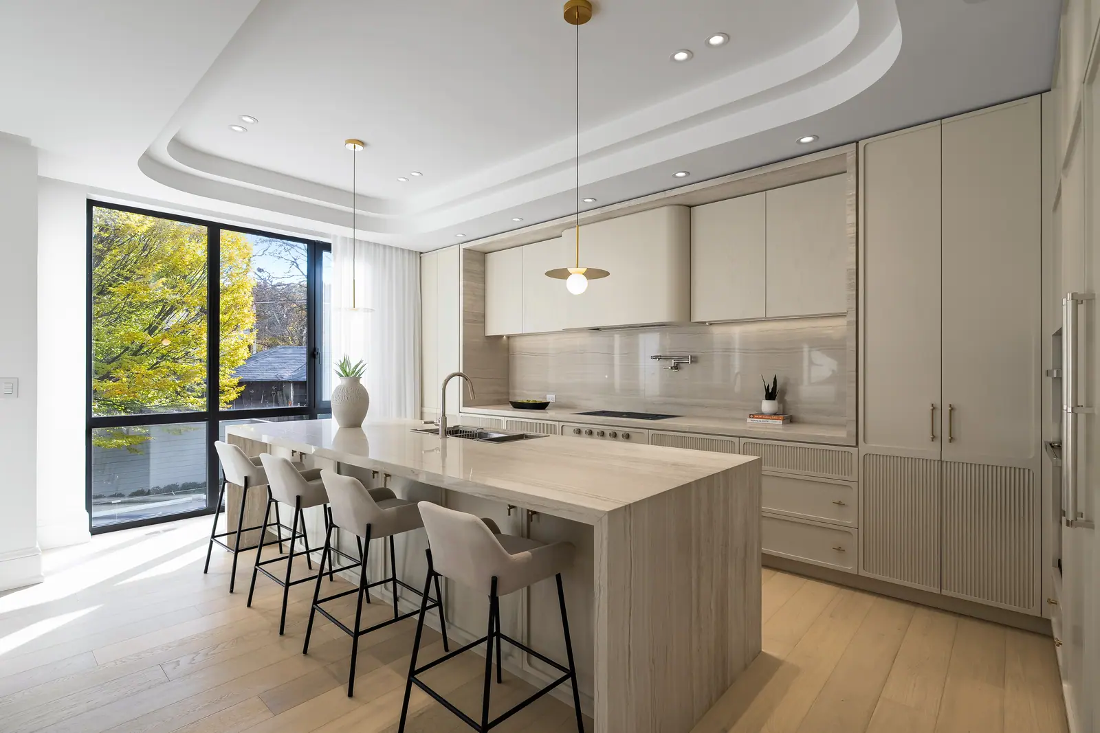 Kitchen with waterfall island and treetop views