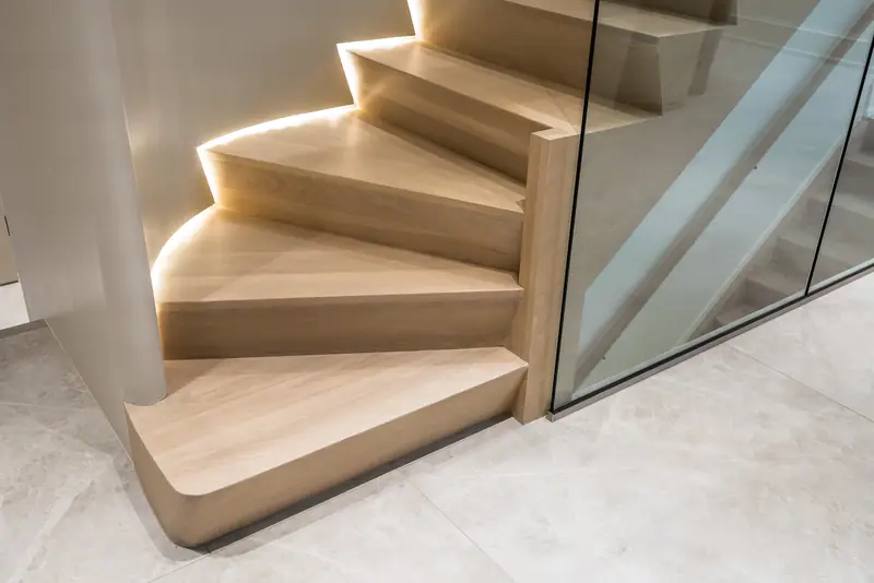 Oak and glass staircase lit from below