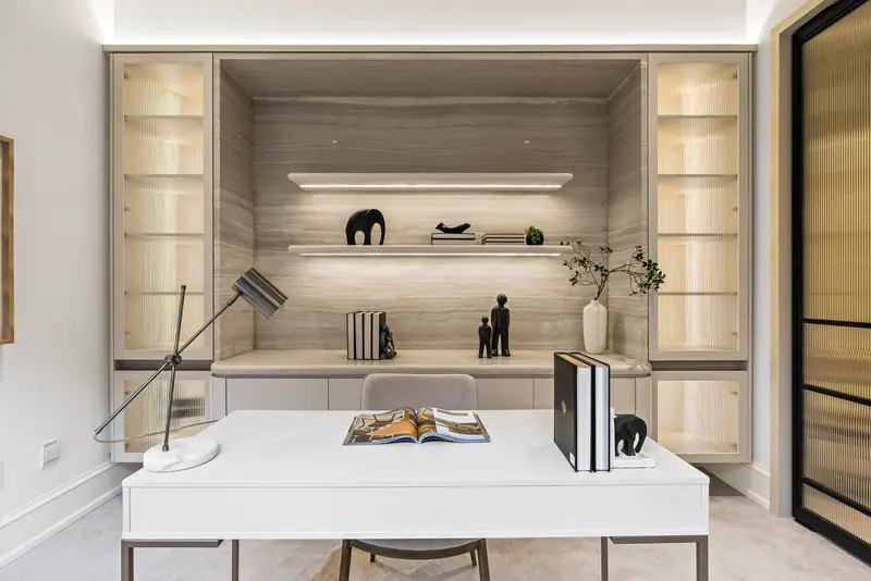 Library with lit travertine shelving
