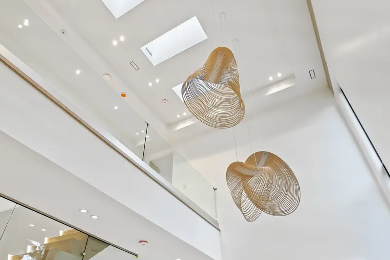 Sculptural pendants in a double-height stairwell