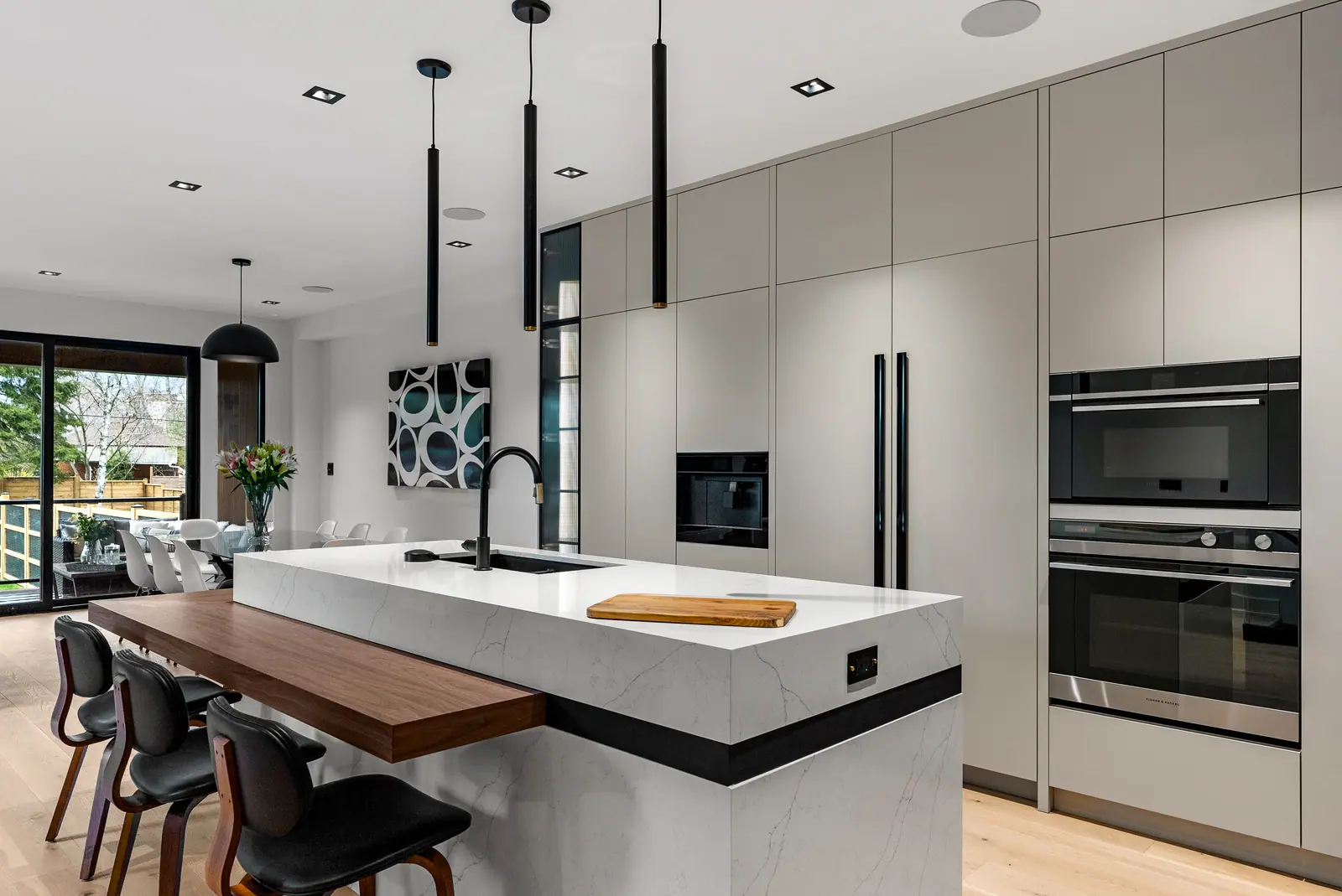 Kitchen with waterfall island and walnut bar