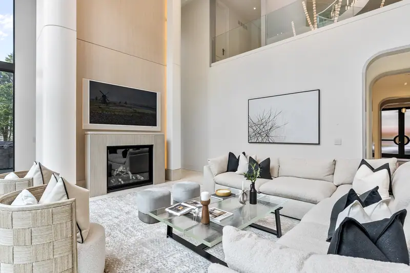 Great room with 23-foot windows, fireplace and white sectional