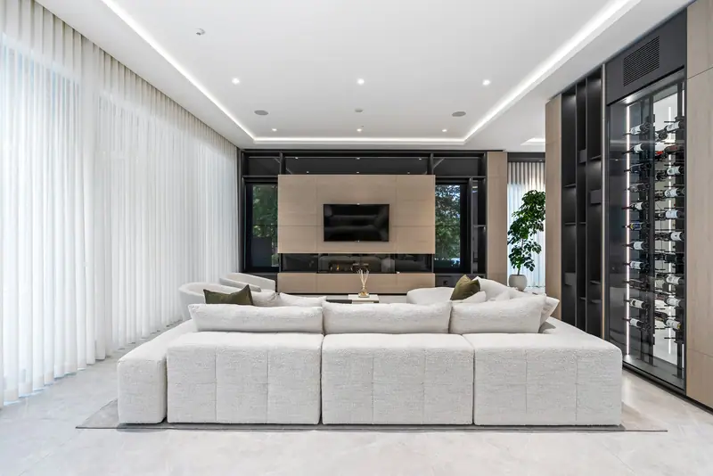 Living room with floating sectional and wine wall