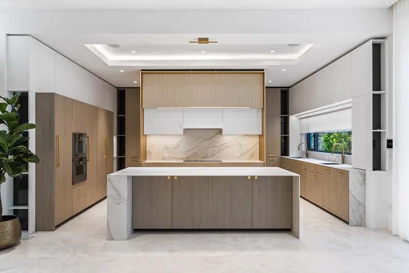 Kitchen with gold-trimmed island and window backsplash