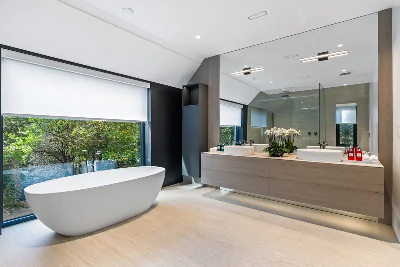 Ensuite with freestanding tub and floating vanity